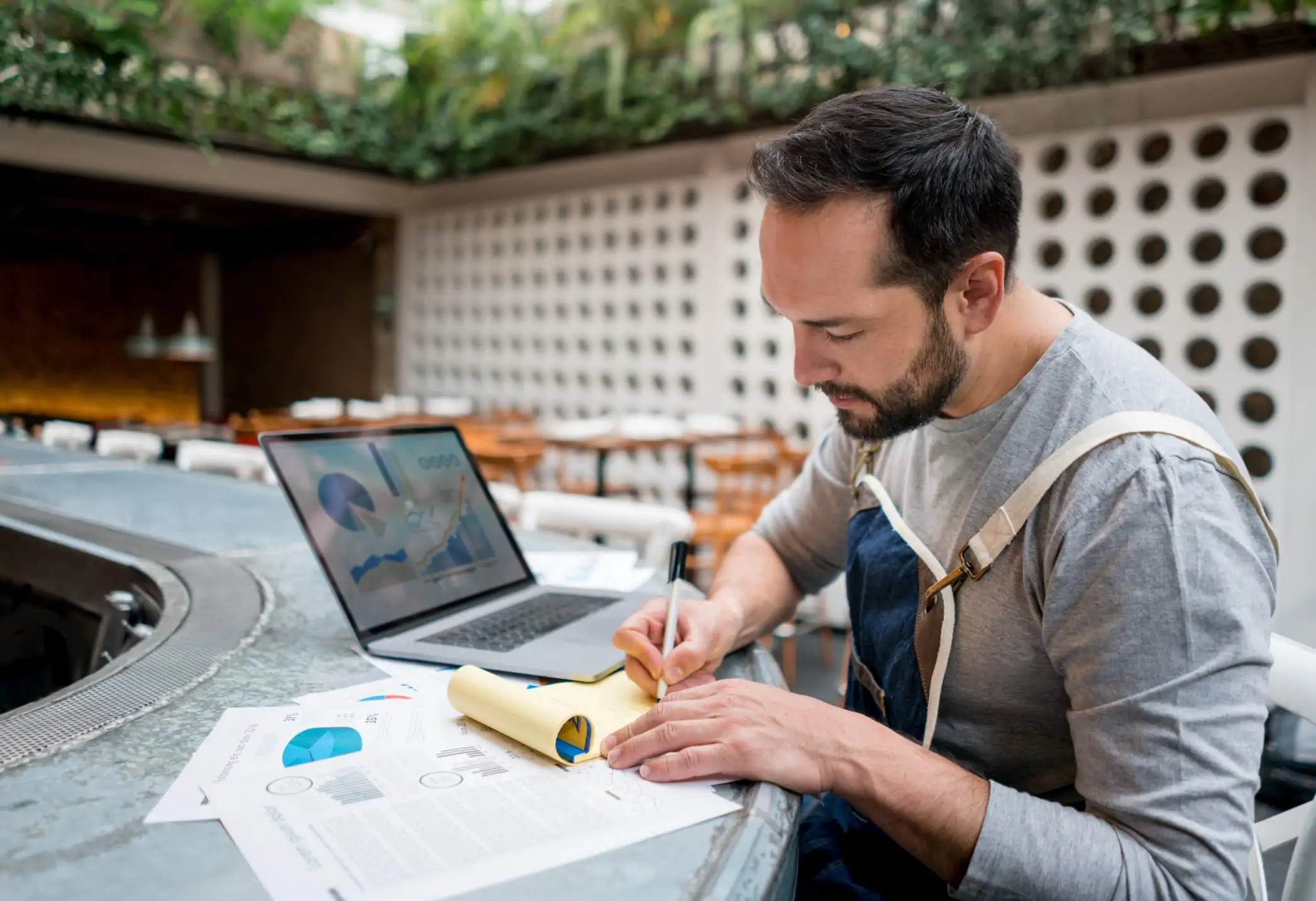 restaurant owner writing notes on table